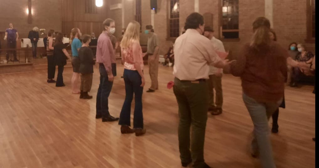 A line of dancers facing their partners, waiting for the next figure
